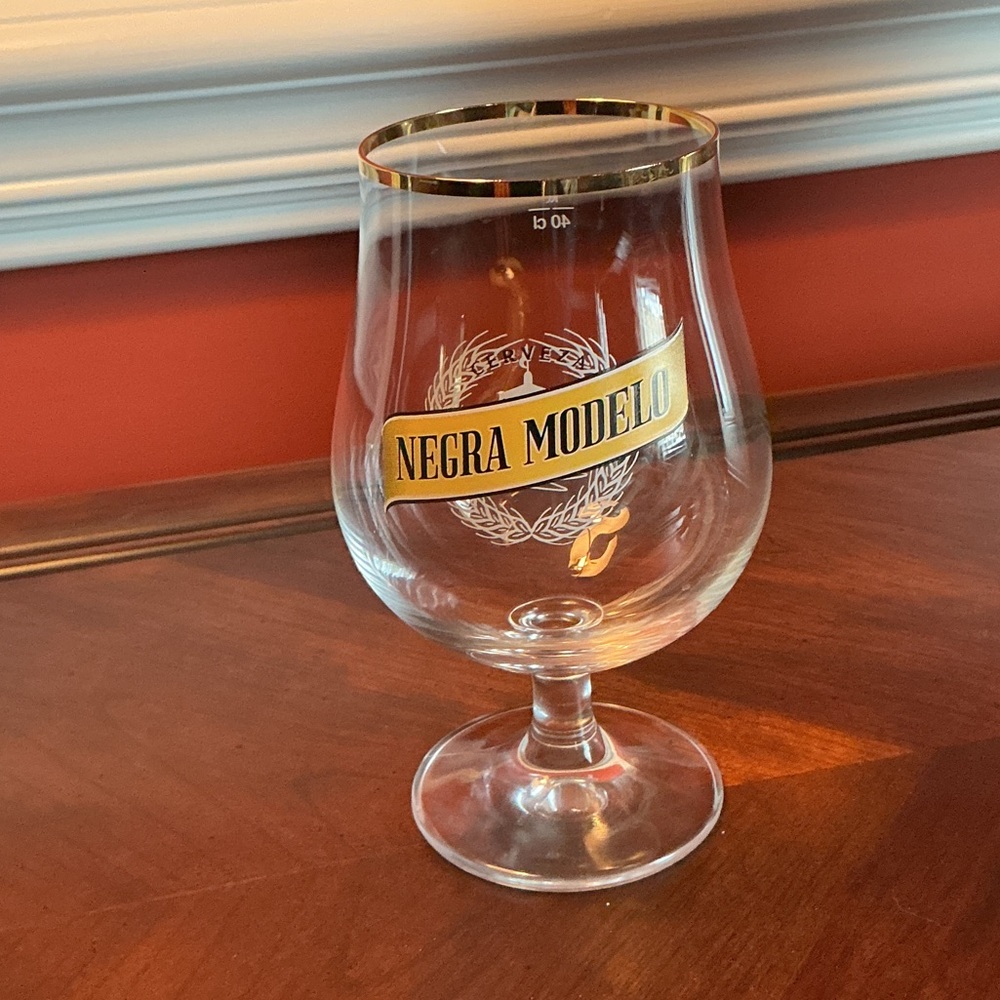 Negra Mondelo branded beer glass with logo and gold rim